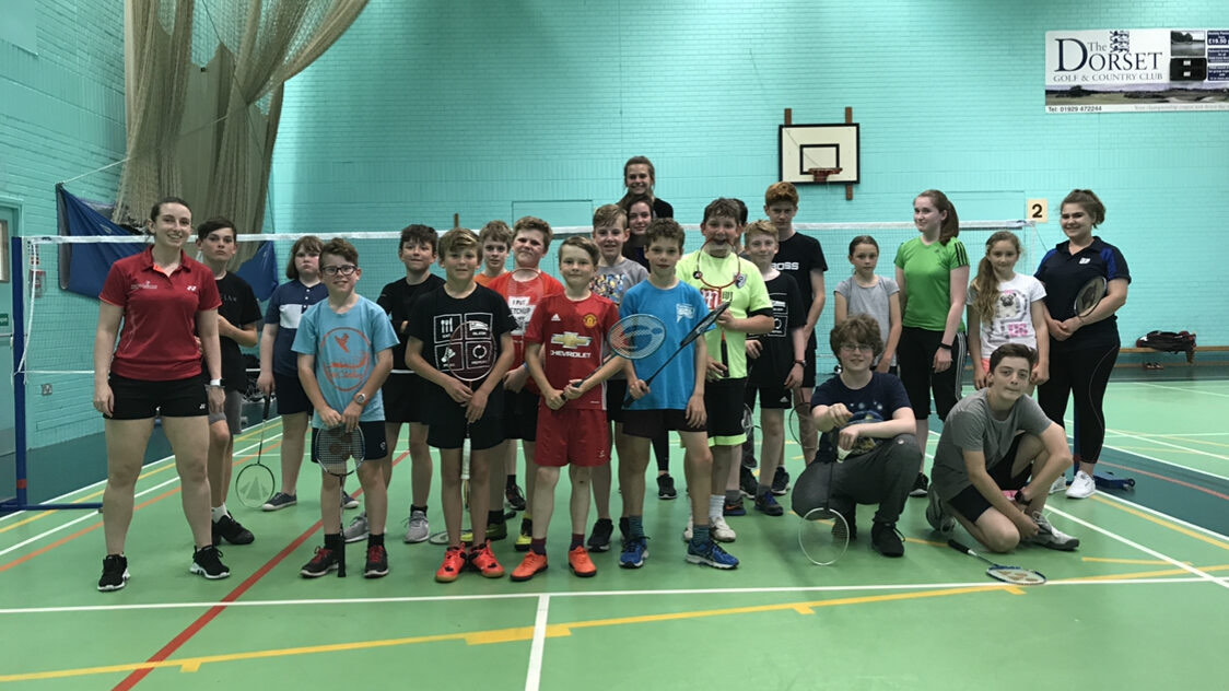 A group of junior players together on court after a coaching session